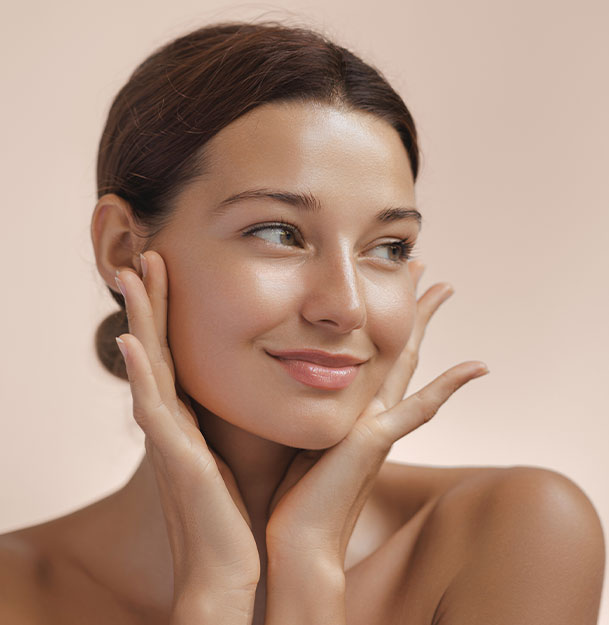 a woman smiling and touching her smooth skin after dermatology in Clearwater